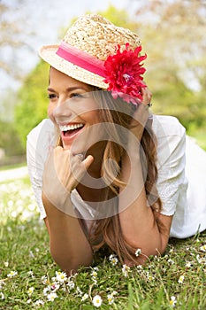 Woman Lying In Field Of Summer Flowers