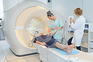 Woman lying in front cat scan machine