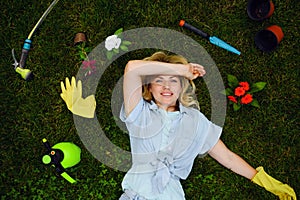 Woman lying on the grass in the garden, gardening