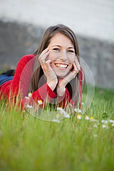 Woman lying in the grass with lots of flowers