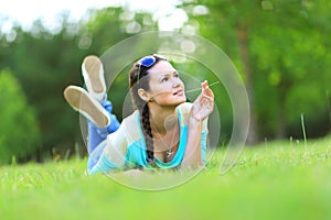 Woman lying on the grass at summer sunset.