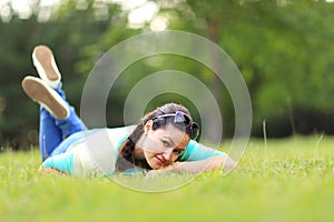 Woman lying on the grass at summer sunset.