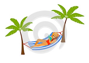 Woman lying in hammock on the beach, reading a book, relaxing