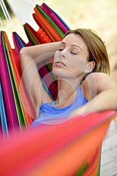 Woman lying in hammock relaxing
