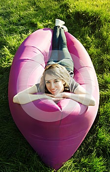 Woman lying in an inflatable sofa