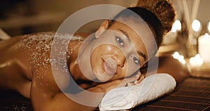 Woman Lying On Massage Table With Salt Scrub