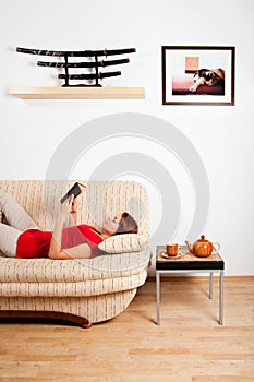 Woman lying and reading a book