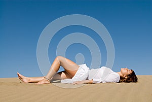 Woman lying in the sand photo