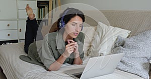 Woman lying on sofa enjoy pleasant virtual videoconference talk