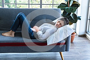Woman lying on the sofa, She is sick and  stomachache or Period cramps