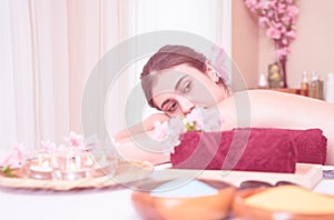 Woman lying on Spa massage bed with spa equipment on foreground