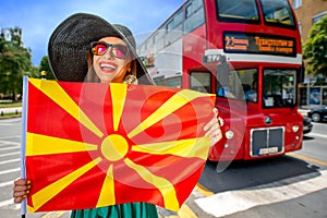 Woman with macedonian flag in Skopje city