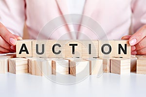 Woman made word Auction with wooden blocks