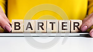 Woman made word barter with wooden blocks, concept