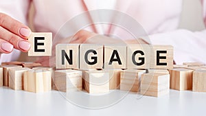 Woman made word engage with wooden blocks