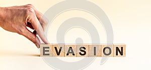 Woman made word EVASION with wood blocks photo