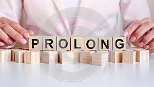 woman made word prolong with wooden blocks photo