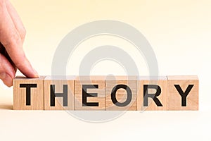 Woman made word THEORY with wood blocks