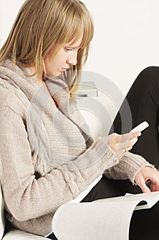 Woman with magazine dialing