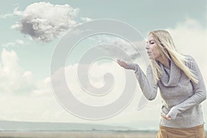 Woman with magical powers creating clouds photo
