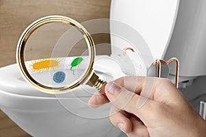 Woman with magnifying glass detecting microbes on toilet bowl in bathroom