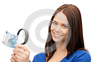 Woman with magnifying glass and euro cash money