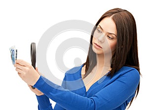 Woman with magnifying glass and euro cash money