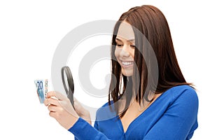 Woman with magnifying glass and euro cash money