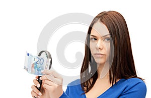 Woman with magnifying glass and euro cash money