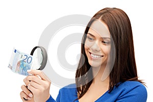 Woman with magnifying glass and euro cash money