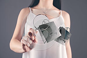 Woman magnifying glass looking at shopping carts icon