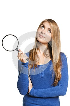 Woman with magnifying glass looking up
