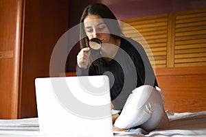 Woman with magnifying glass looking for work on the computer