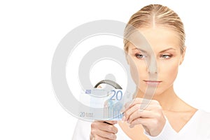 Woman with magnifying glass and money