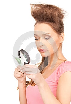 Woman with magnifying glass and money