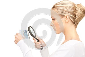 Woman with magnifying glass and money