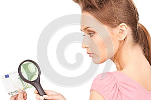 Woman with magnifying glass and money