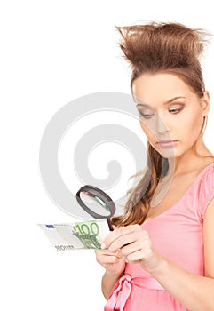 Woman with magnifying glass and money