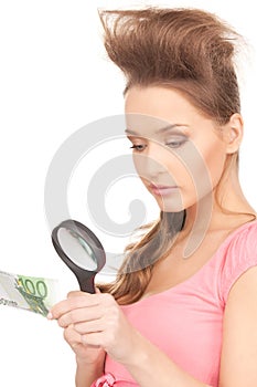 Woman with magnifying glass and money