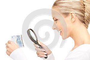 Woman with magnifying glass and money