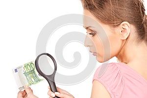 Woman with magnifying glass and money