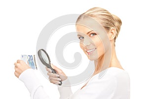 Woman with magnifying glass and money