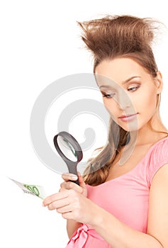 Woman with magnifying glass and money