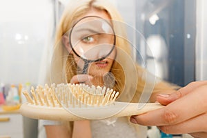 Woman magnifying hair brush
