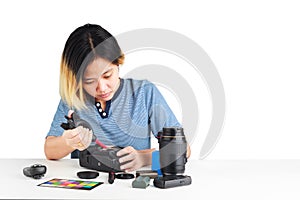 Woman maintenance a DSLR Camera with dust brower