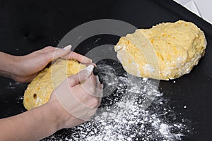 Woman make dough for bakery on black table