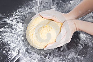 Woman make dough for homemade bakery on black kitchen