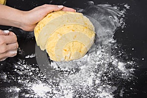 Woman make dough for homemade bakery on black table