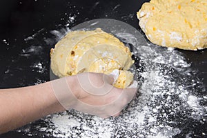 Woman make dough for homemade bakery on black wooden table