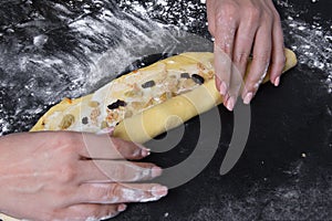 Woman make dough for sweet homemade backery on black background photo